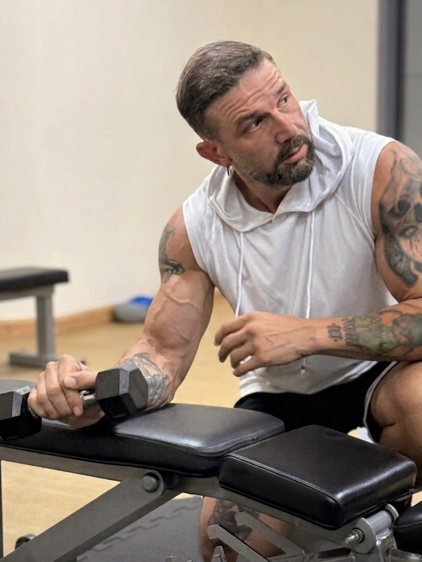 Goksel Ipekesen fitness coach training with dumbbell